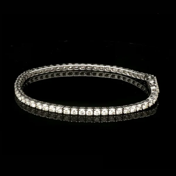 7 pointer diamonds set in a classic platinum tennis bracelet with single line diamonds by Neeva Jewelry - Image 3